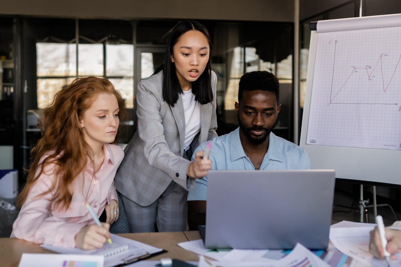 Business team discussing strategy in a modern office setting with diverse members.